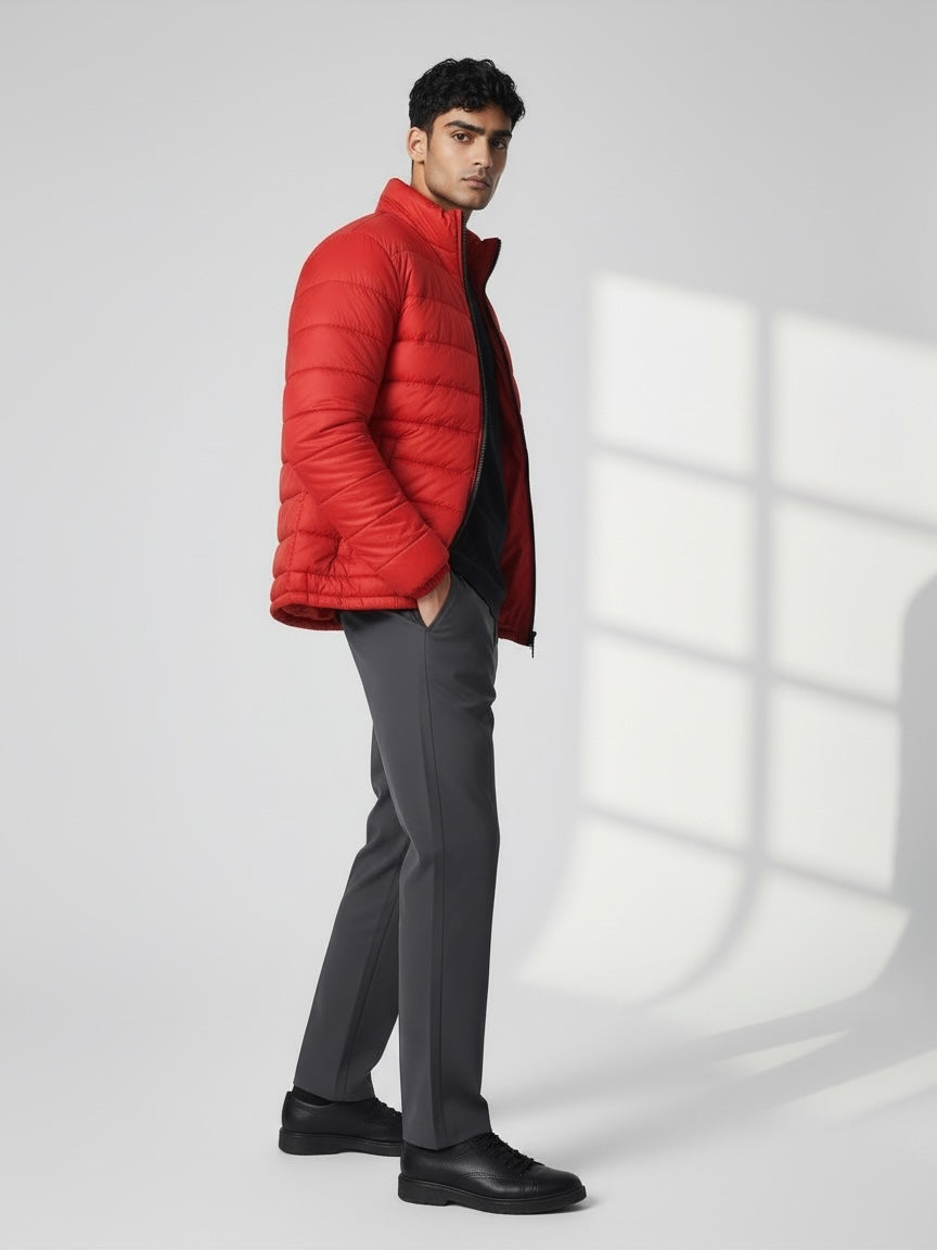 FITTING red lightweight quilted puffer jacket with high neck collar worn by a man in grey trousers