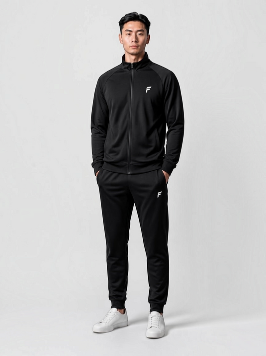 FITTING men's black full-zip athletic tracksuit with a high collar, tailored joggers, and white sneakers.