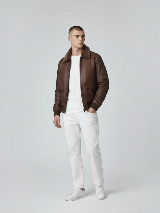 FITTING brown leather bomber jacket with shearling collar, ribbed cuffs, and utility sleeve pocket on a male model.