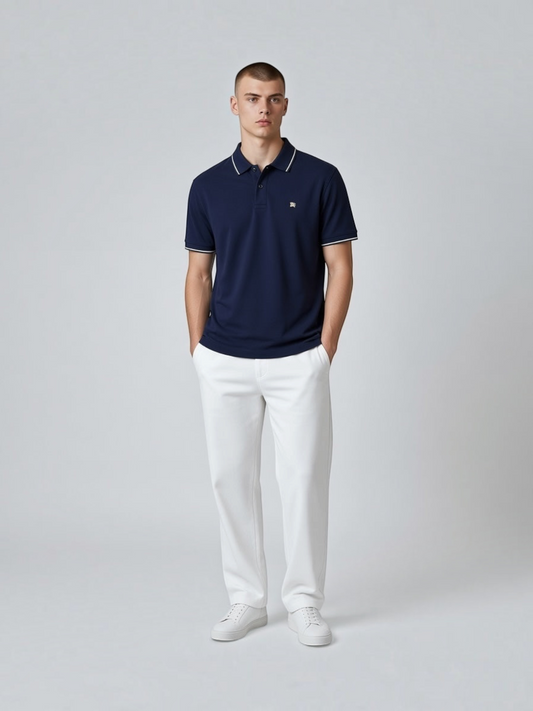 FITTING navy blue cotton polo shirt with white contrast tipping on collar and sleeves worn by a male model